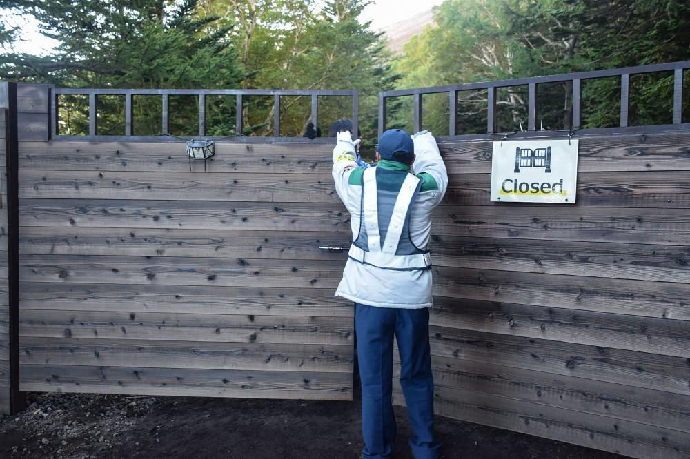 This photo taken on September 10, 2024 shows the temporary gate at the Yoshida Exit at the 5th station of Mount Fuji being closed to coincide with the end of the summer mountain climbing season, at Fujiyoshida, Yamanashi prefecture. — AFP pic