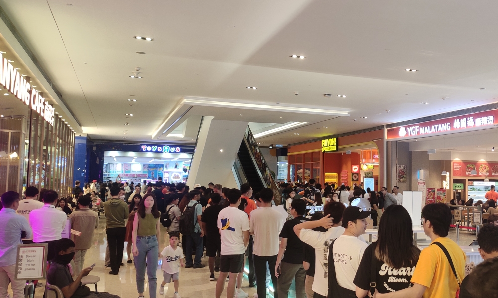 Eager fans wait outside the restaurant, FUIYOH! It’s Uncle Roger, which is slated for its grand opening at Pavilion KL, 1pm today. — Picture by Kenneth Tee