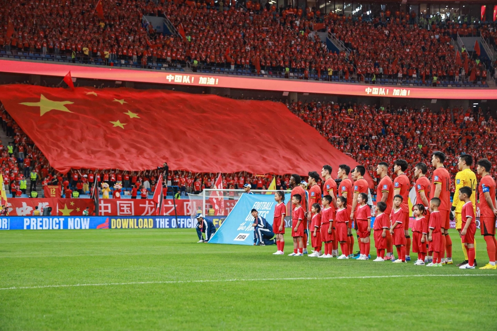 China's players sing the national anthem prior to the 2026 FIFA World Cup qualifier football match between China and Saudi Arabia in Dalian, in northwestern China's Liaoning province on September 10, 2024. — AFP pic