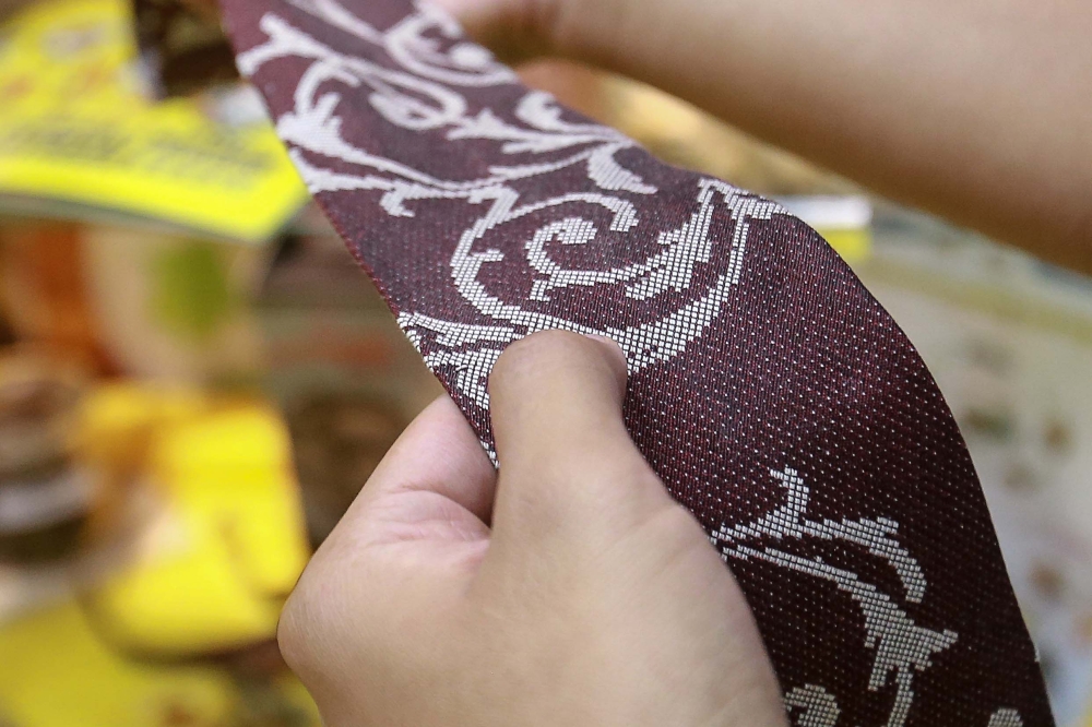 A necktie with a local motif made from pineapple leaf fibres is displayed at the Malaysian Pineapple Industry Board booth at the 2024 Malaysian Agriculture, Horticulture and Agro-tourism Exhibition at the Malaysian Agro Exposition Park Serdang (MAEPS) September 11, 2024. — Picture by Sayuti Zainudin