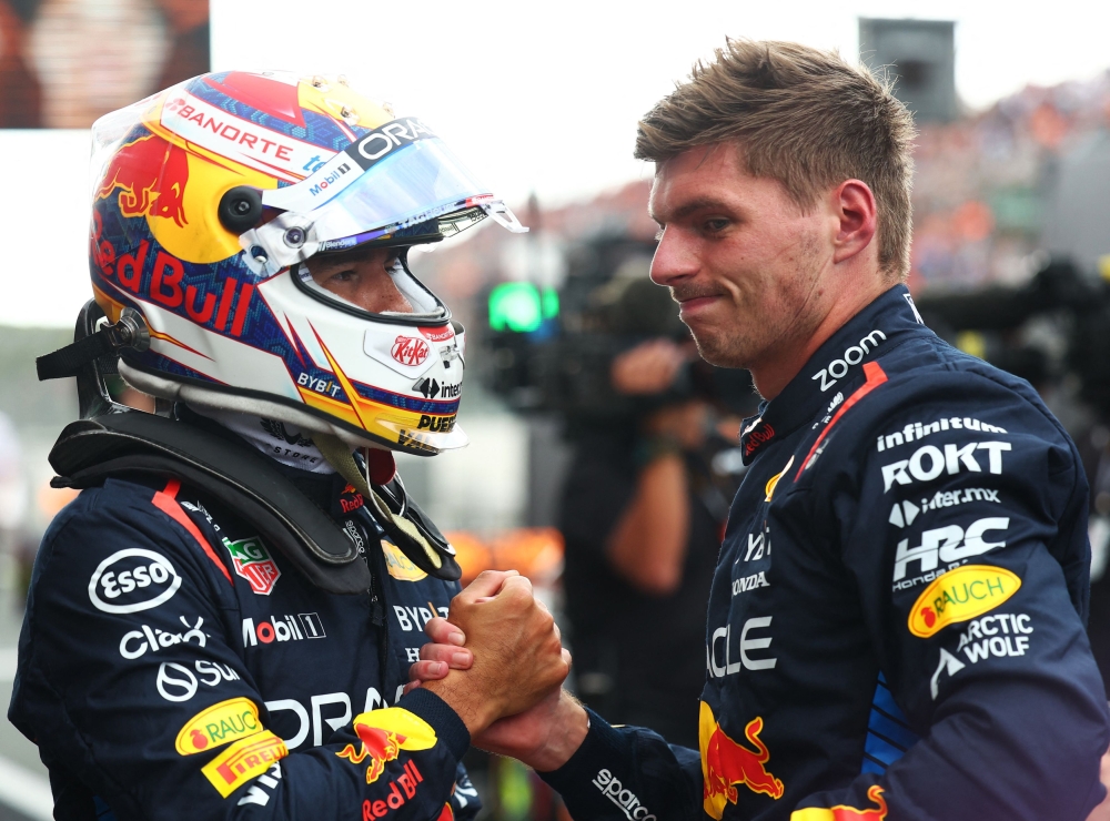 Max Verstappen (right) and teammate Sergio Perez have been busy working on finding solutions to Red Bull Racing's slump in form. — Reuters pic