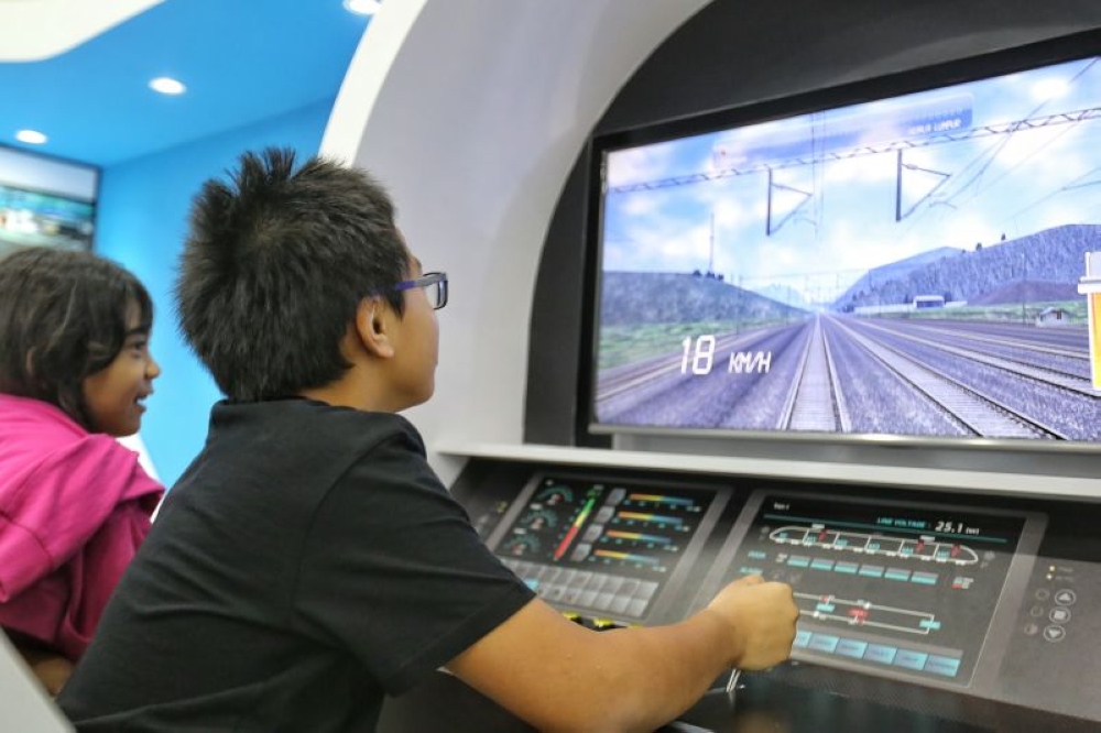 A child plays the role of a train captain in KL-Singapore HSR project exhibition at NU Sentral, Kuala Lumpur in this file photo taken on June 15, 2016. — Picture by Saw Siow Feng