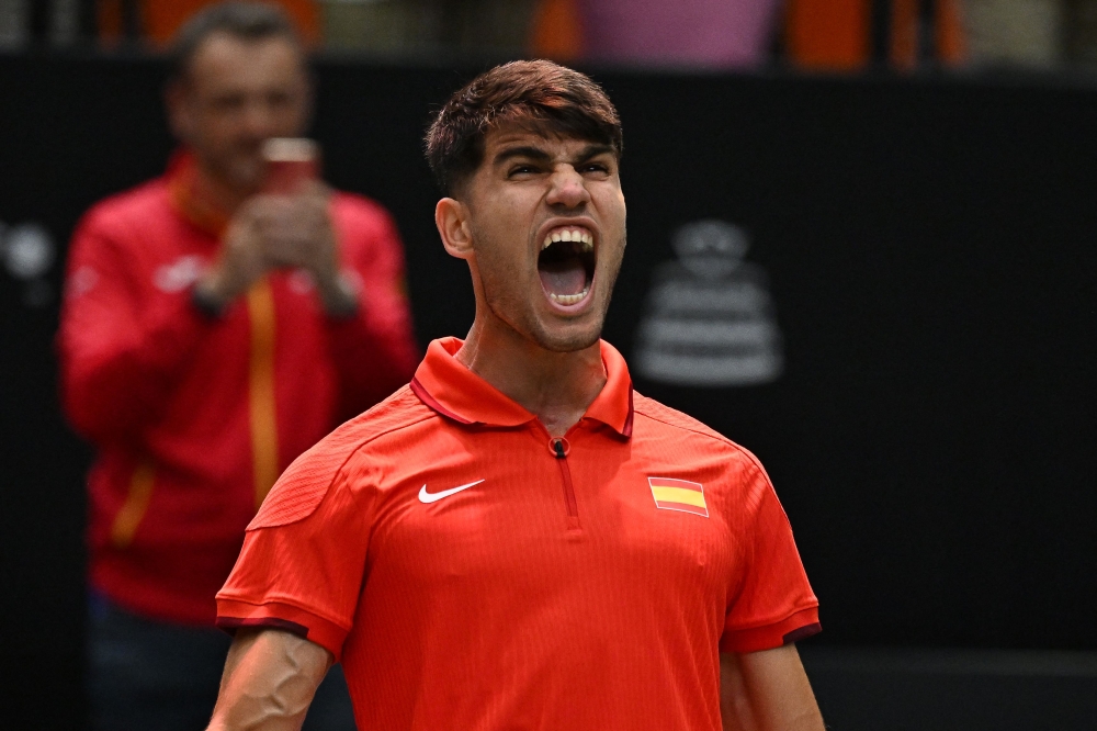 Spain’s Carlos Alcaraz celebrates after winning against France’s Ugo Humbert during the group stage men’s singles match between France and Spain of the Davis Cup tennis tournament in Valencia on September 13, 2024. — AFP pic