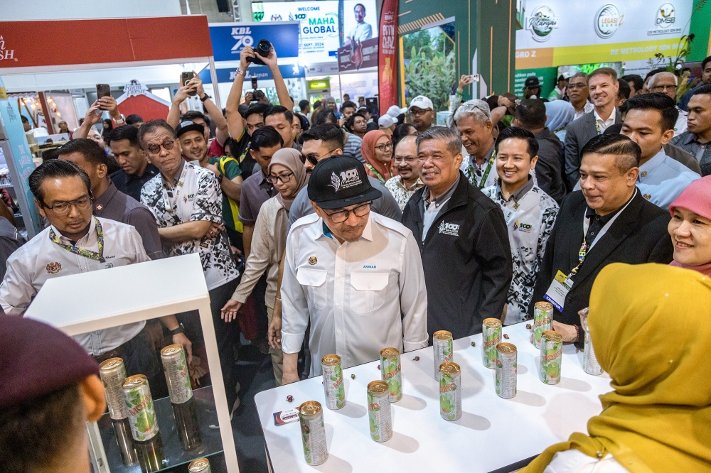 Prime Minister Datuk Seri Anwar Ibrahim and Agriculture (front, centre) and Food Security Minister Datuk Seri Mohamad Sabu (to his right) visit a booth after the launch of the Malaysian Agriculture, Horticulture and Agro-tourism Exhibition (Maha) 2024 at the Malaysia Agro Exposition Park Serdang (MAEPS) in Serdang September 11, 2024. — Picture by Firdaus Latif