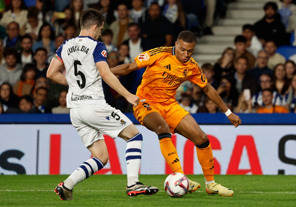 Real Madrid's Kylian Mbappe in action with Real Sociedad's Igor Zubeldia at the Reale Arena, San Sebastian, Spain September 14, 2024. — Reuters pic