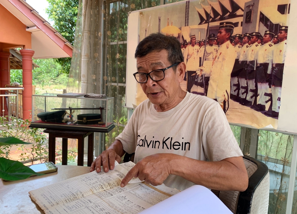 Captain Wan Marzudi Wan Omar, 64, reviews documents on his involvement in the Royal Malay Regiment (RAMD) after receiving his commissioning letter in 1982, in Pasir Puteh, Kelantan, September 15, 2024. — Bernama pic 