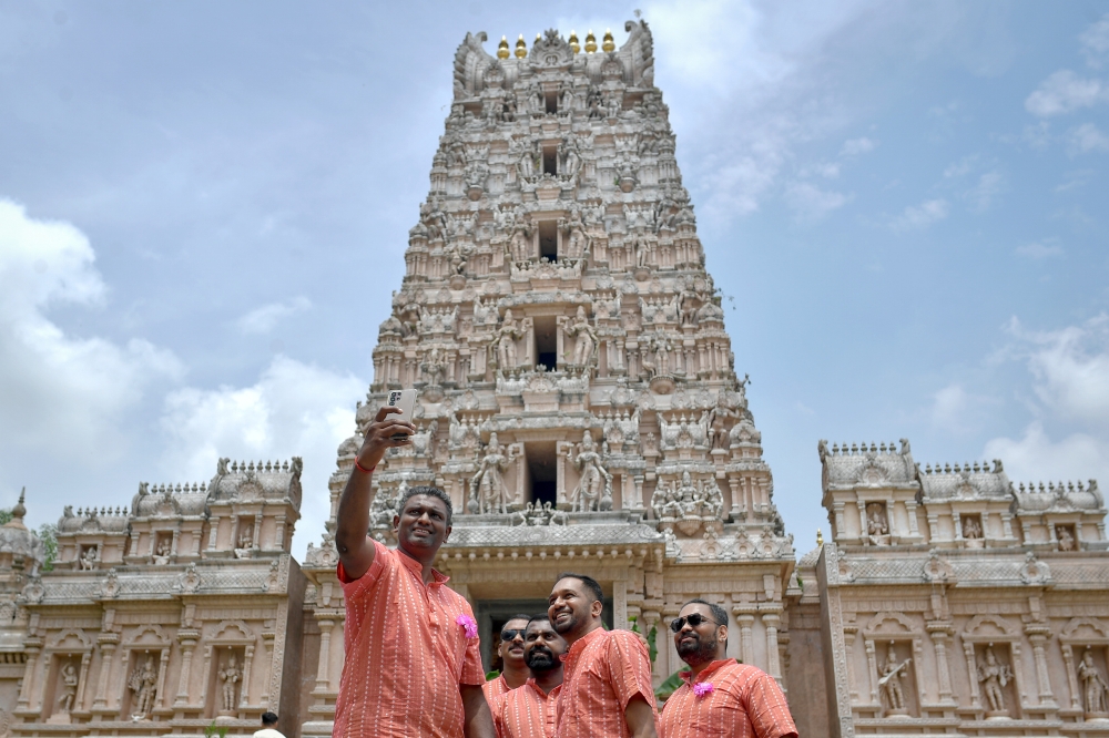 Visitors took the opportunity to snap selfies with family members at the Sri Shakti Devasthanam temple recently. — Bernama pic 