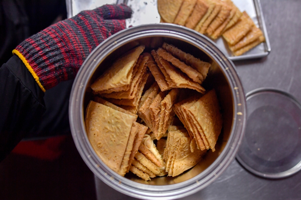 Owned by husband and wife, Ng Joo Leong, 46, and Kwi Ai Fang, 45, the main attraction of Ah Ma House is that visitors can witness firsthand how traditional ‘kuih kapit’ (love letters) are baked using charcoal. — Bernama pic 