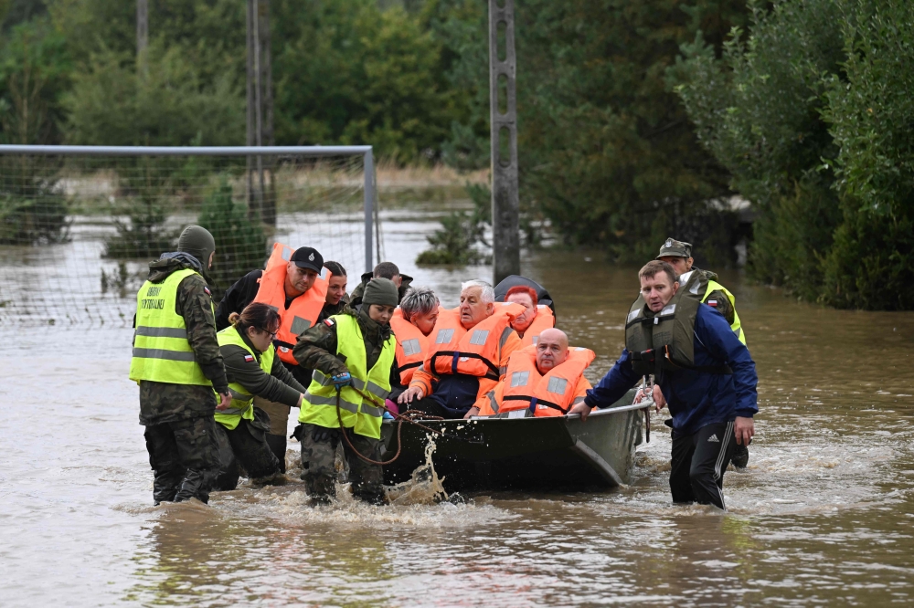 Polish rescuers and soldiers evacuate local residents in the village of Rudawa, southern Poland, on September 15, 2024. — AFP pic