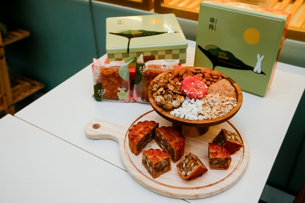 Traditional ingredients make-up of a mixed nut mooncake featuring various nuts and seeds such as almond, sesame, melon and walnut. — Picture by Raymond Manuel