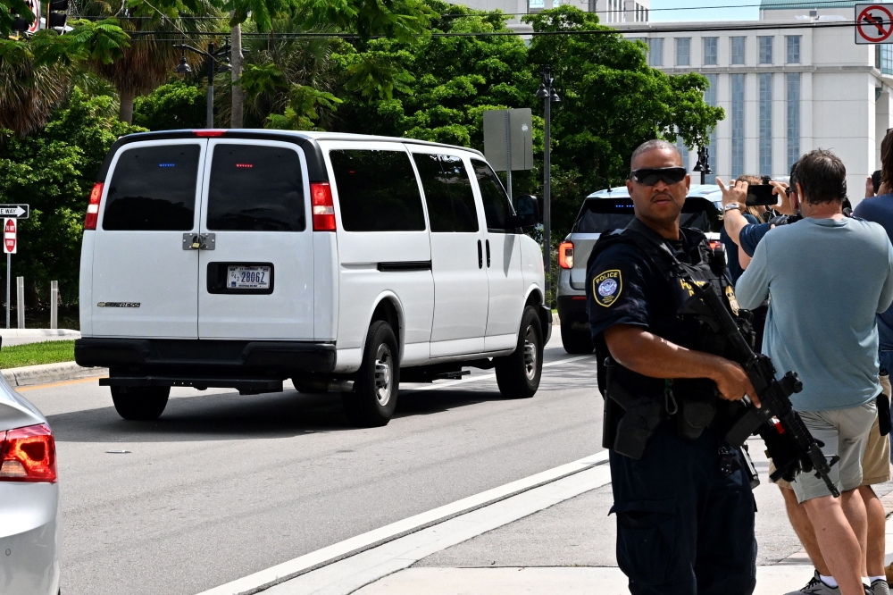 A van believed to be carrying Ryan Wesley Routh, the suspect in an apparent assasination attempt on former US President Donald Trump, leaves the Paul G. Rogers Federal Building and US Courthouse on September 16, 2024 in West Palm Beach, Florida. — AFP pic