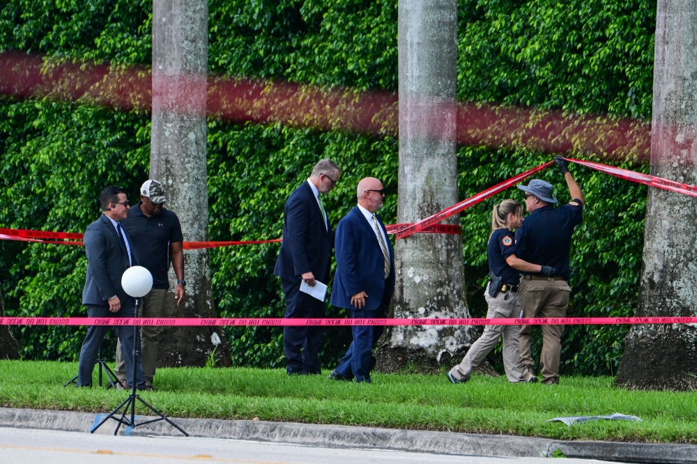 Law enforcement personnel continue to investigate the area around Trump International Golf Club, after an apparent assassination attempt on Republican presidential nominee and former US President Donald Trump, after a gunman was found at the Trump’s golf course, in West Palm Beach, Florida September 16, 2024. — Reuters pic