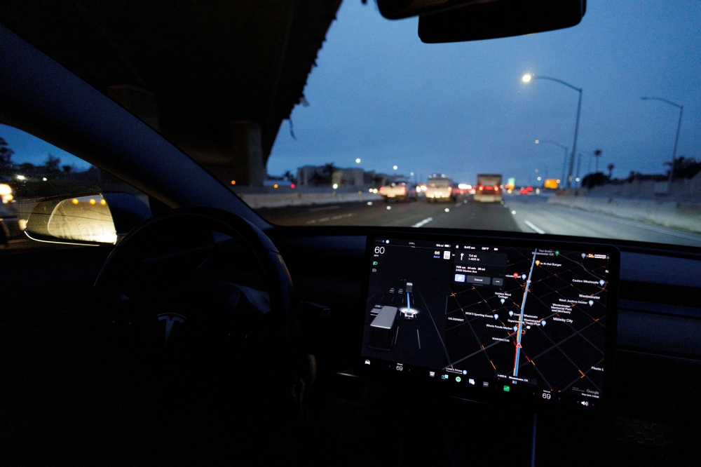 A Tesla Model 3 vehicle drives on autopilot along the 405 highway in Westminster, California. — Reuters pic