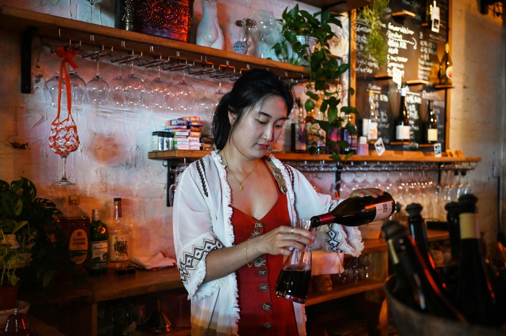 Sophie Zhou runs a wine bar in Beijing. — AFP pic