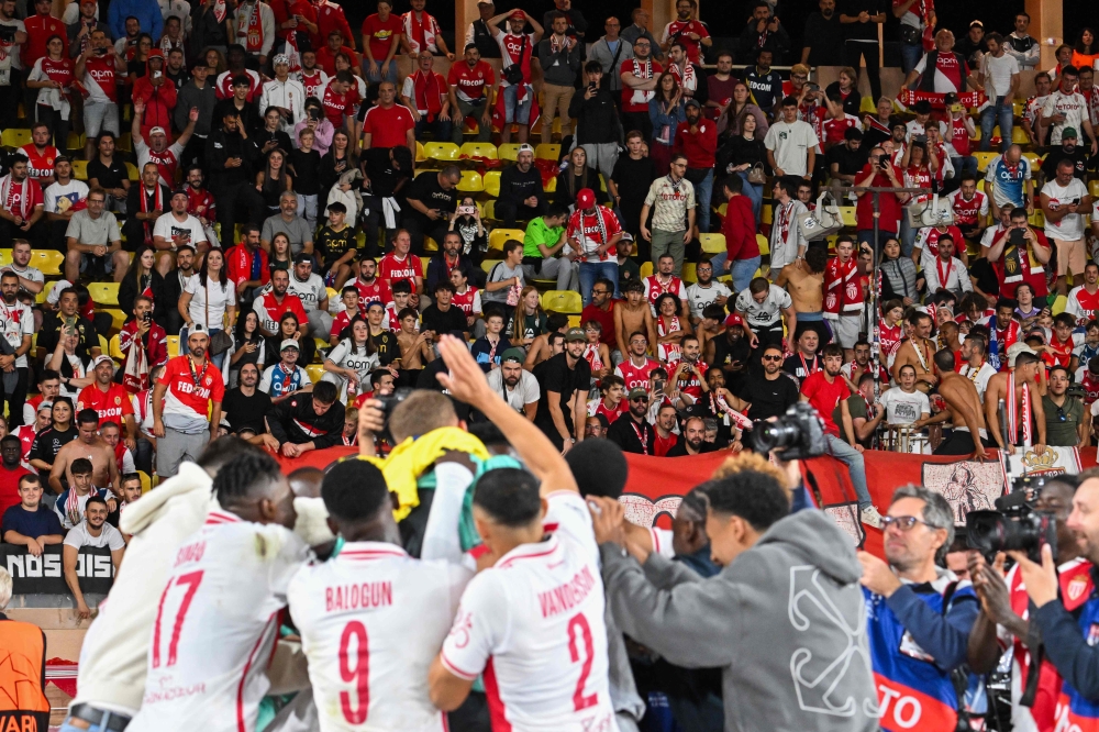 Monaco's players celebrate with their supporters after winning the Uefa Champions League 1st round day 1 football match between AS Monaco and FC Barcelona at the Louis II Stadium in the Principality of Monaco on September 19, 2024. — AFP pic