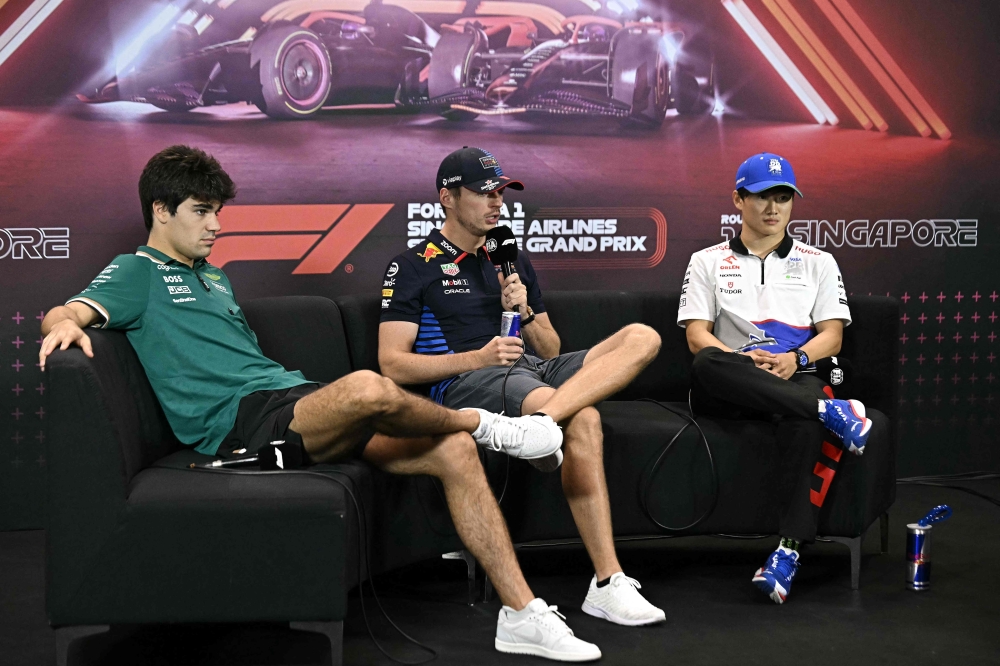 (Left to right) Aston Martin's Canadian driver Lance Stroll, Red Bull Racing's Dutch driver Max Verstappen, and RB's Japanese driver Yuki Tsunoda take part in a press conference ahead of the Formula One Singapore Grand Prix night race at the Marina Bay Street Circuit in Singapore on September 19, 2024. — AFP pic