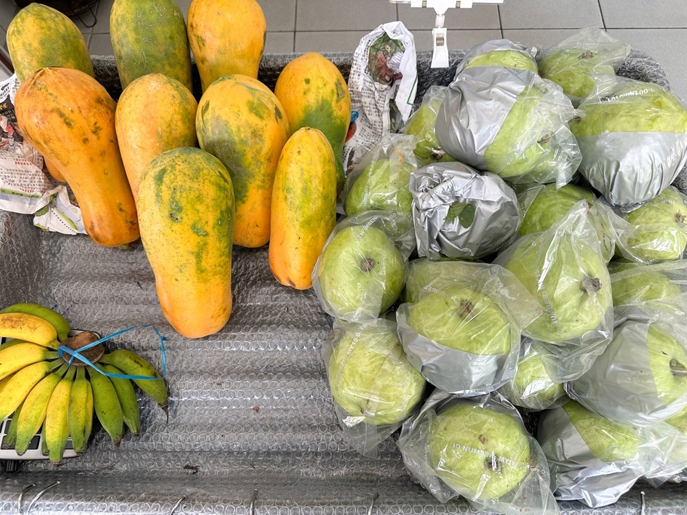 On Friday, you can pick up fresh fruits and even cowslip creeper blossoms, brought in from Ipoh and Teluk Intan. — Picture by Lee Khang Yi