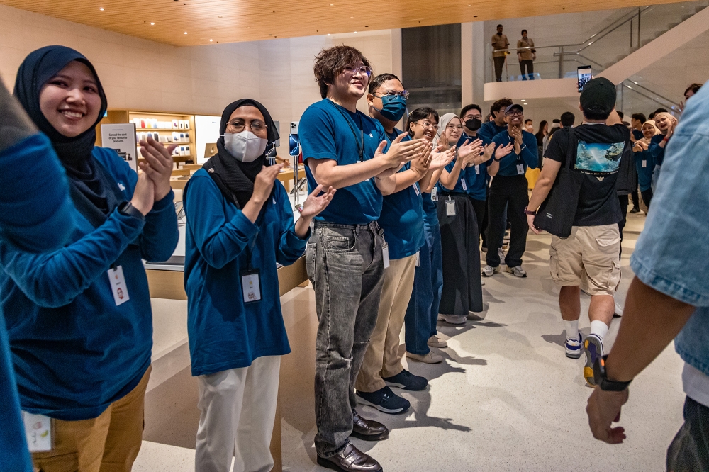 Apple staff welcome customers as they enter an Apple store during the first day of the sale of the iPhone 16 smartphone at the Tun Razak Exchange (TRX) in Kuala Lumpur September 20, 2024. — Picture by Firdaus Latif