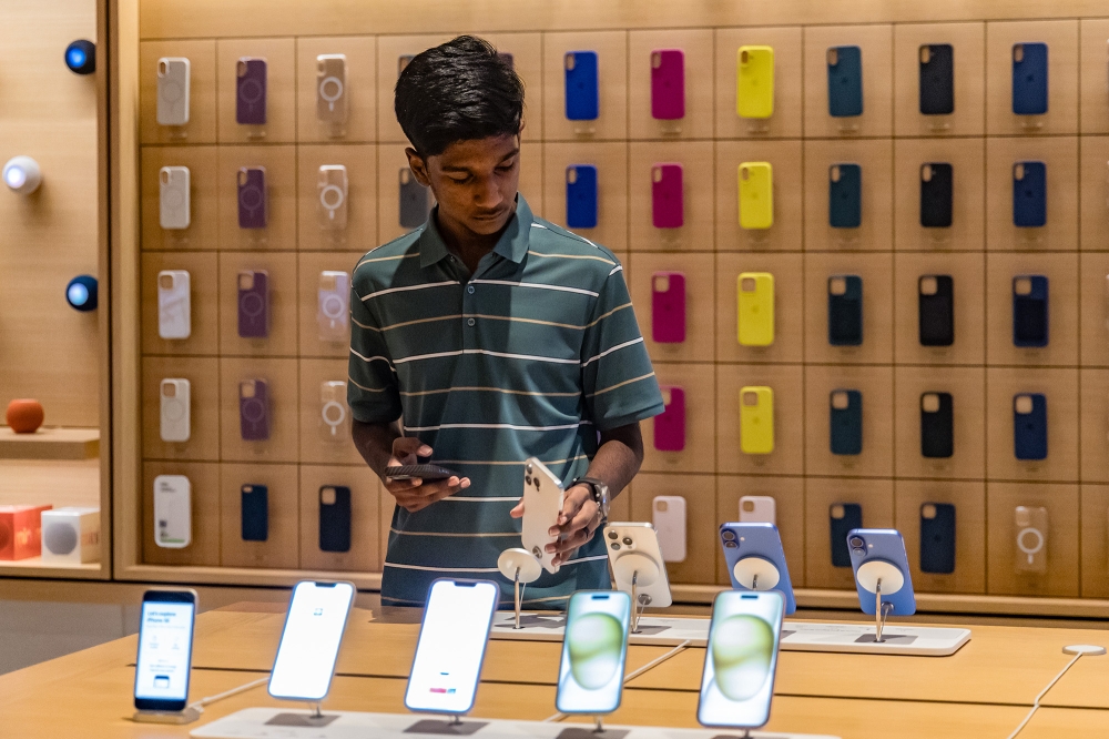 A customer tries out the newly launched iPhone 16 at Tun Razak Exchange (TRX) in Kuala Lumpur, September 20, 2024. — Picture by Firdaus Latif