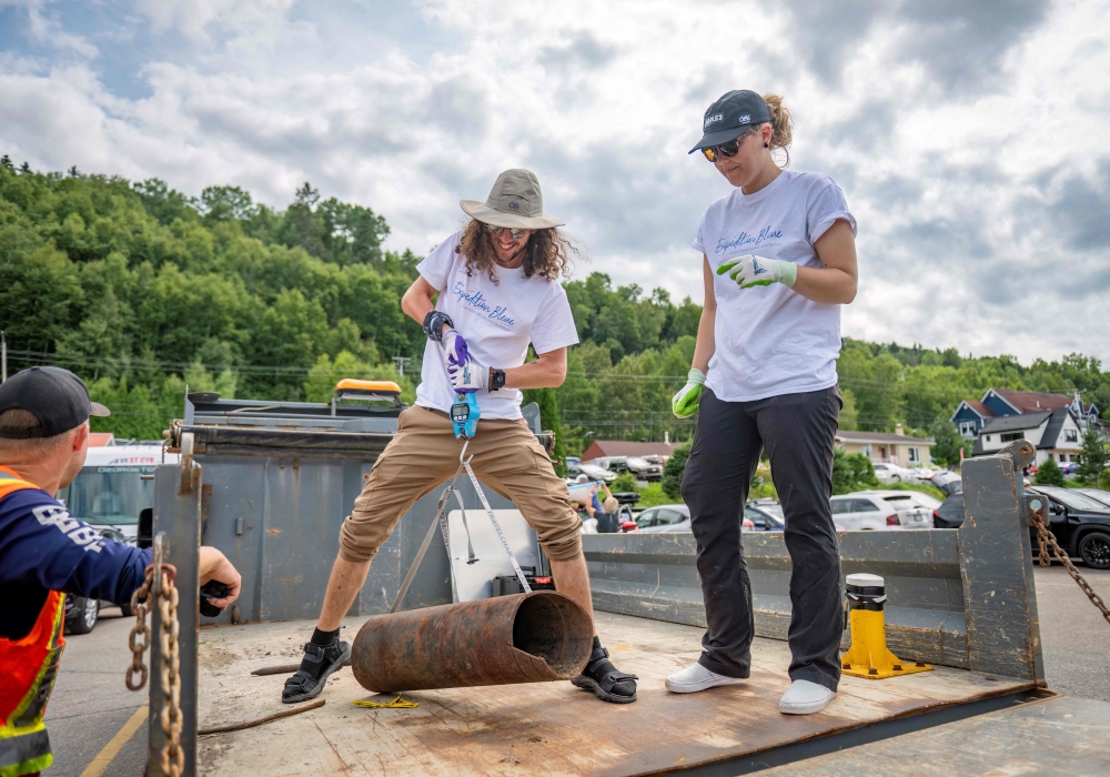 Maximilien Rolland, videographer and director and Viridiana Jimenez, marine biologist and communications specialist for Reseau Quebec Maritime, weigh a metal pipe picked up on the shore as part of the blue expedition, in L'Anse-Saint-Jean, Quebec July 23, 2024. — AFP pic