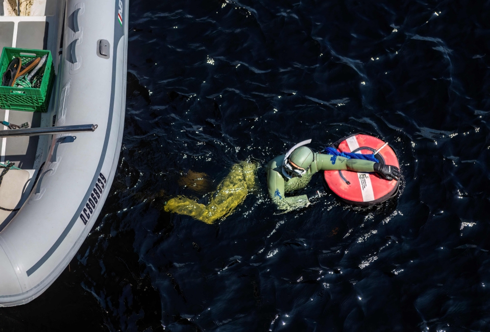 Anne-Marie Asselin, Biologist and Expedition Leader of the Blue Organization, dives to collect waste in the Saguenay Fjord during the Blue Expedition, in Petit-Saguenay, Quebec July 24, 2024. — AFP pic