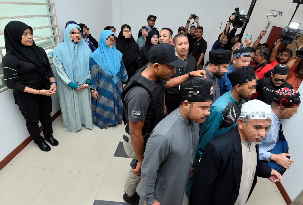 A total of 19 people, including the CEO of Global Ikhwan Services and Business Holding (GISBH) and his wife, were produced before the Shah Alam magistrate's court seeking a seven-day remand order, effective September 18, 2024. — Bernama pic 