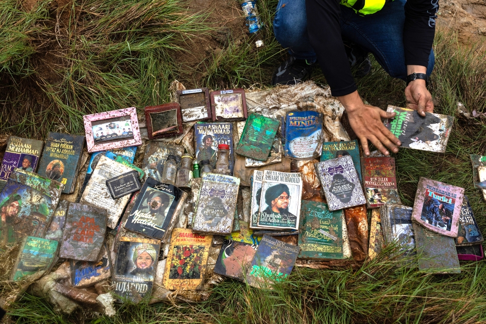 A view of various books and documents buried along the riverbank during a police raid on residences of the senior management families of Global Ikhwan Service & Business Holdings (GISBH) Sdn Bhd in Kampung Panji September 21, 2024. — Bernama pic