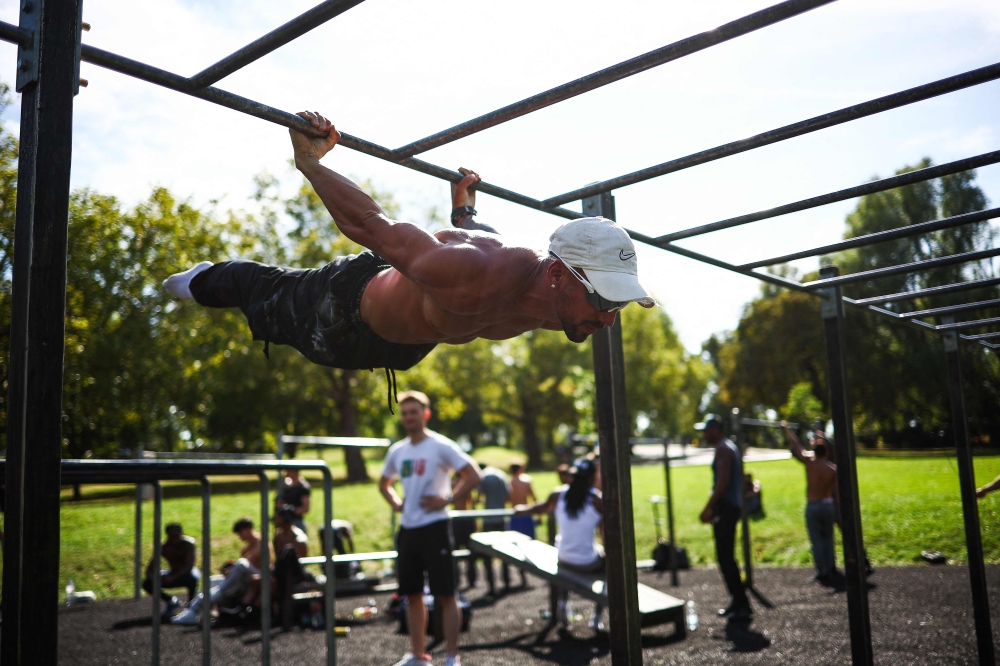 People take part in a social and community training event for ‘World Pull Up day’ organised by British anti knife crime charity Steel Warriors at the calisthenics gym they created by melting the knife blades handed over by the Metropolitan Police, at Finsbury Park, in London September 14, 2024. — AFP pic