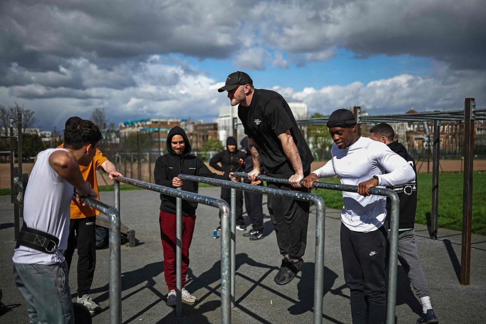 Head of Marketing & Community at a British anti knife crime charity Steel Warriors Christian d’Ippolito attend a ‘Skills calisthenics’ training session at the calisthenics gym created by British anti knife crime charity Steel Warriors by melting the knife blades handed over to the Metropolitan Police, at Ruskin Park, in London March 23, 2024. — AFP pic