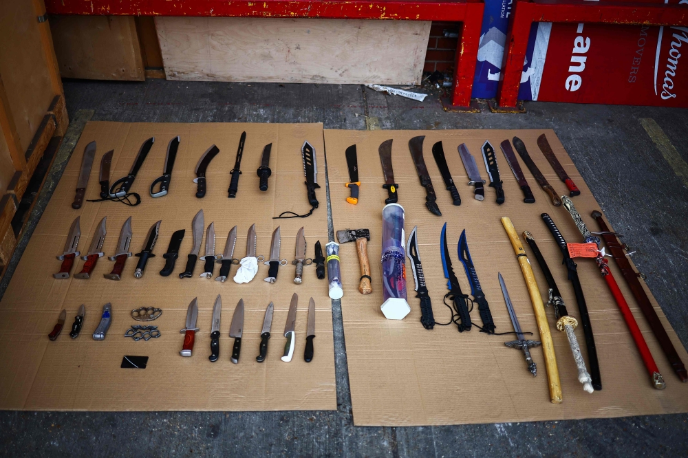 A photograph taken on January 17, 2024 shows a small selection of the several tonnes of knives handed over to the British anti knife crime charity Steel Warriors, by the Metropolitan Police, after having been confiscated on the streets of London, and now placed in storage at a facility in London. — AFP pic