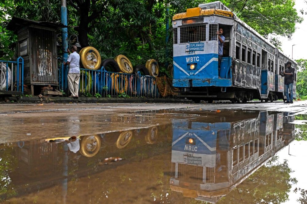 A tram is pictured at its depot in Kolkata September 8, 2024. The single-storey trams — painted in uniform stripes of bright blue and white, with a sunshine yellow top — trundle at best at around 20 kilometres per hour, if not snarled in traffic blocking its route. — AFP pic