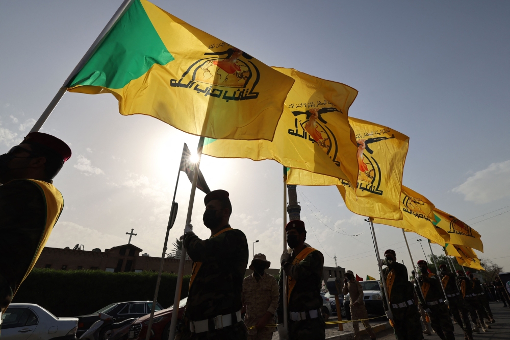 Members of Iraq’s Hezbollah Brigades attend the funeral of a military commander in Baghdad September 22, 2024. A militant from the Hezbollah Brigades armed group was killed on September 20, in a strike targeting the pro-Iran faction in Syria, the group said, blaming Israel for the attack. — AFP pic