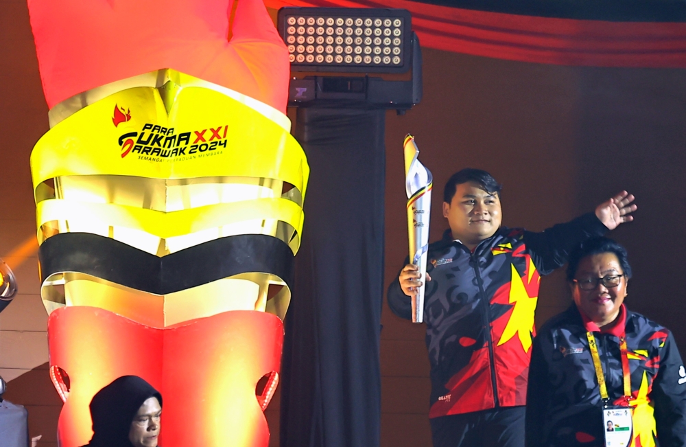 national powerlifting champion Bonnie Bunyau Gustin lights the torch during the official opening ceremony of the 2024 Malaysia Para Games (Para Sukma) at Stadium Perpaduan Petra Jaya Kuching September 22, 2024. — Bernama pic