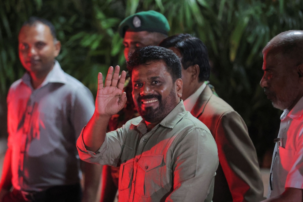 Anura Kumara Dissanayake, leader of the National People's Power (NPP) party, greets as he leaves the election commission after he claimed the victory in the presidential election, in Colombo September 22, 2024. — Reuters pic  