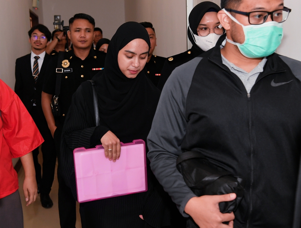 Social media influencer Aisyah Hijanah Azhari, 26, who also the wife of Alif Teega, pleads not guilty over 10 charges of misappropriating public funds. — Bernama pic