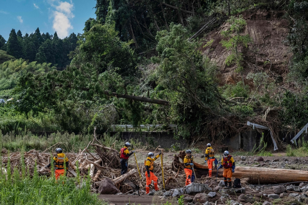 Rescue personnel search for missing people along the Tsukada river after houses were swept away by raging floodwaters following heavy rain in Wajima city, Ishikawa prefecture on September 23, 2024. — AFP pic