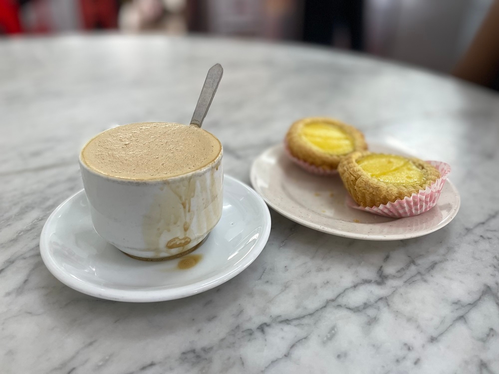 The hot foamy white coffee and the crispy, fluffy egg tarts are a must at the Kedai Makanan Nam Heong. — Picture by John Bunyan