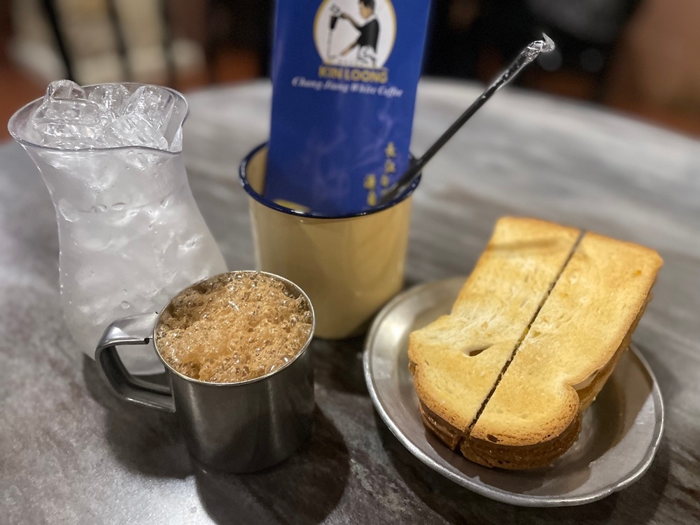 The iced white coffee and kaya butter toast are popular picks for customer in Kin Loong Chang Jiang White Coffee. — Picture by John Bunyan