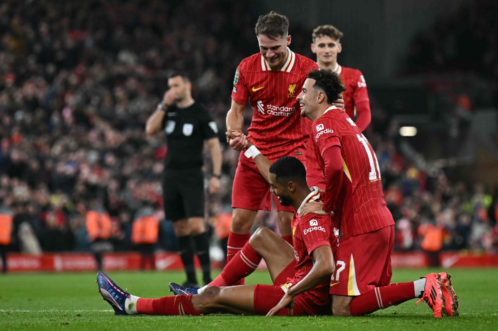 Liverpool's Cody Gakpo (centre) celebrates with his team after scoring a goal during the English League Cup third round football match between Liverpool and West Ham United at Anfield in Liverpool, north west England on September 25, 2024. — AFP pic