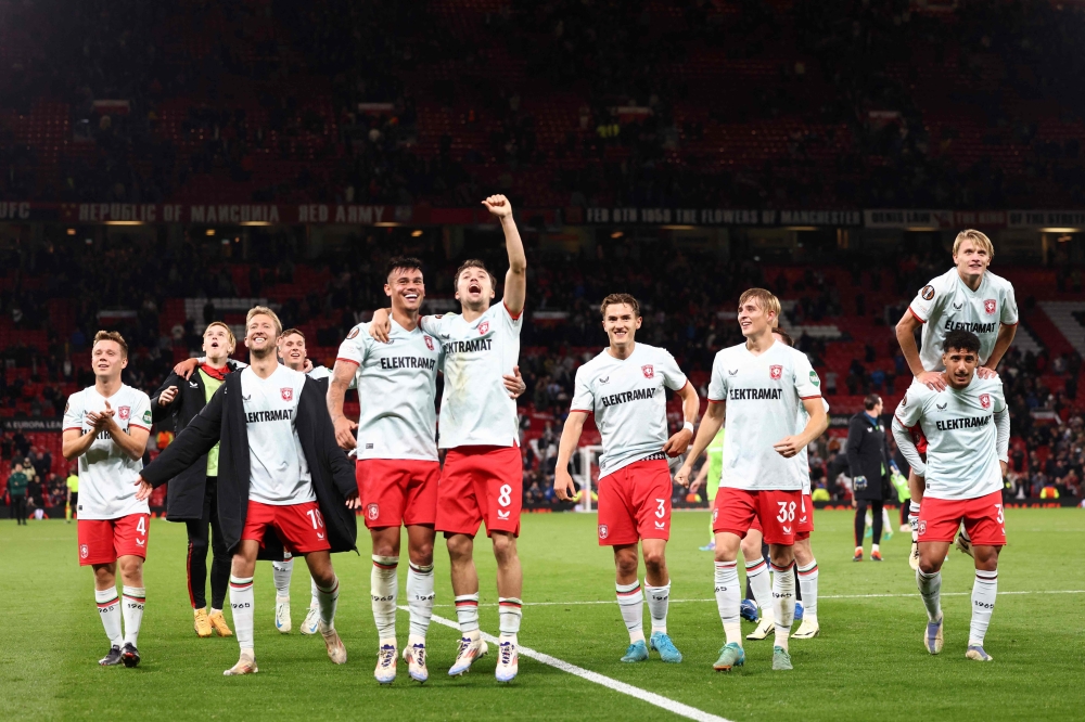 FC Twente players react after securing draw in the Uefa Europa league stage football match between Manchester United and FC Twente at Old Trafford stadium in Manchester, north west England, on September 25, 2024. — AFP pic