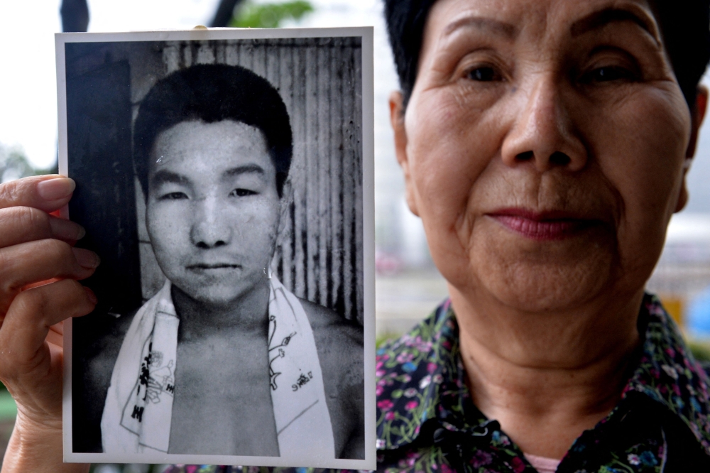 This file photo taken on May 20, 2013 shows Hideko Hakamada, sister of former boxer Iwao Hakamada who had been on death row in Japan for 47 years, showing a picture of her young brother Iwao, during an interview outside the Tokyo Detention House in Tokyo. — AFP pic