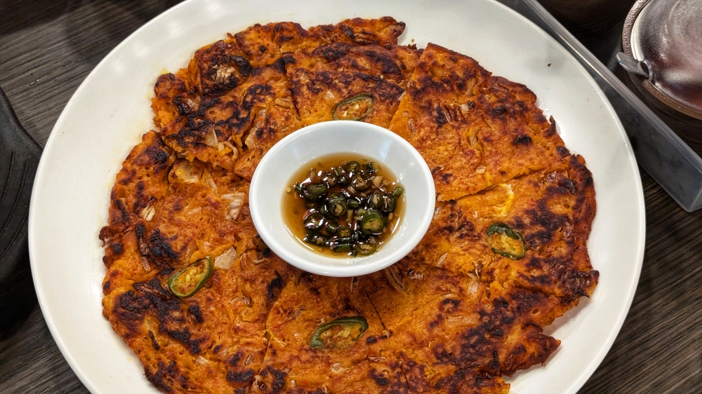 The tangy kimchi pancake is a perfect pairing for the sweet-ish ‘makgeolli’. — Picture by Ethan Lau