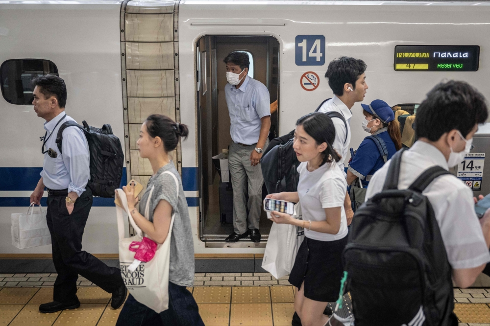 Passengers disembark from a Shinkansen at Tokyo Station in Tokyo July 25, 2024. — AFP pic