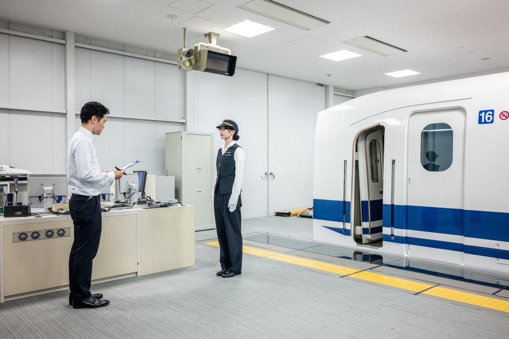 Trainer Kohei Taniuchi talks to trainee Hazuki Okuno after a training session at JR’s central training centre in the city of Mishima, Shizuoka Prefecture July 23, 2024. — AFP pic