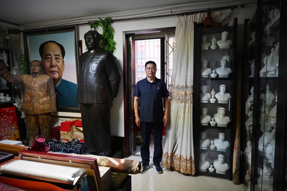 Former soldier and Mao memorabilia collector Feng Gang stands in a room filled with statues and portraits of late Chinese communist leader Mao Zedong at his home in Baotou September 7, 2024. — AFP pic