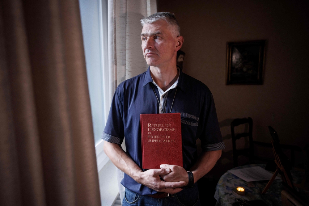 Priest of the ‘Trois Vignes’ parish, Thierry Moser poses as he holds ‘Ritual of Exorcism and Prayers of Supplication’ in a room in which priests conduct exorcism sessions at the Home Saint Joseph in Brussels September 11, 2024. — AFP pic