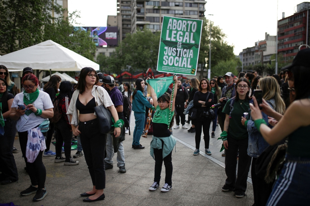 A child holds up a sign that reads ‘Legal abortion is social justice’ during a rally ahead of International Safe Abortion Day, in Santiago, Chile September 27, 2024. — Reuters pic  