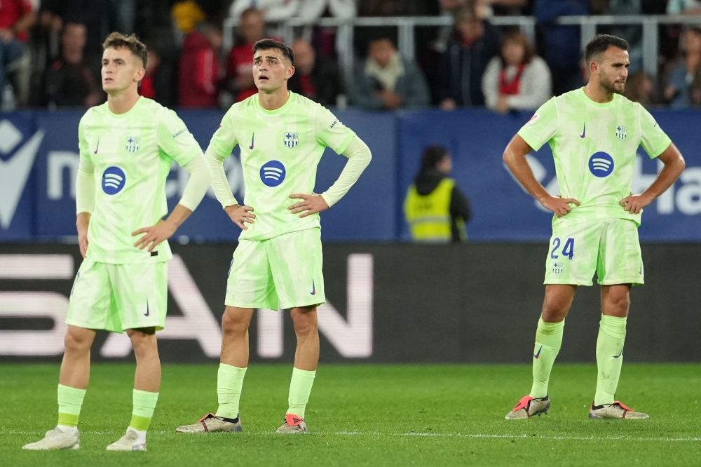 Barcelona’s Pedri and his teammates react to Osasuna’s third goal during their La Liga match in Pamplona September 28, 2024. — AFP pic