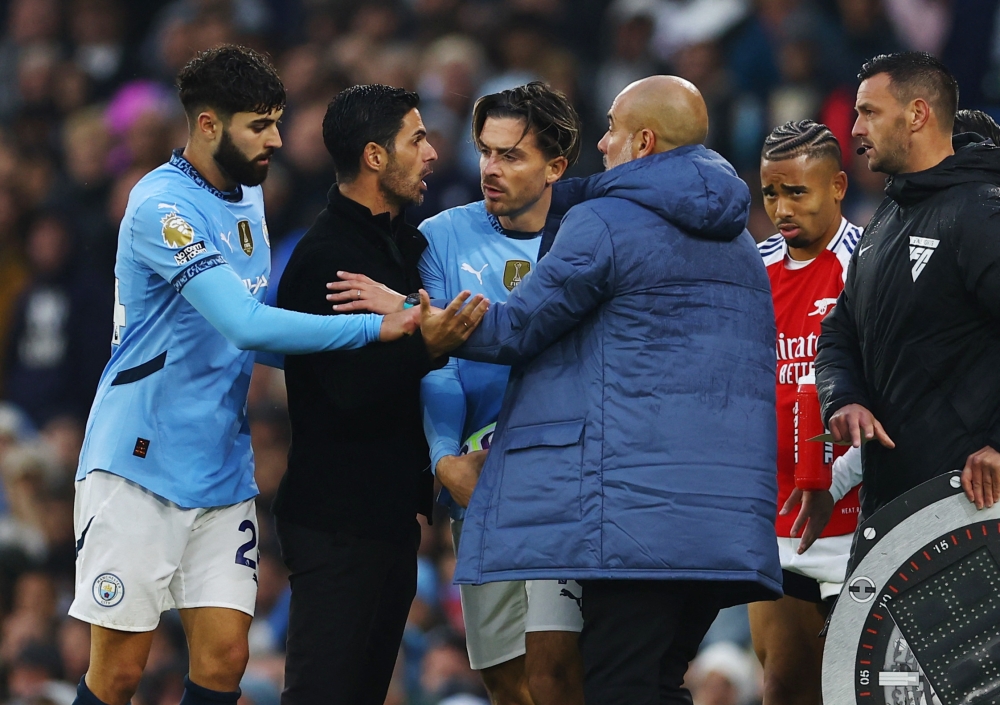 Arsenal manager Mikel Arteta and Manchester City manager Pep Guardiola clash during their teams’ Premier League match in Manchester September 22, 2024. — Reuters pic