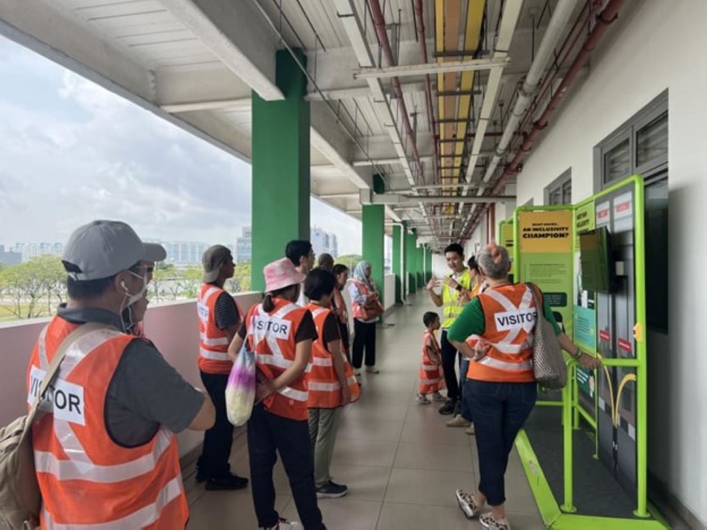 Tour visitors at the Tower Transit Bulim Bus Depot as part of My Community's Open My Factory tour on Sept 20, 2024. — TODAY pic